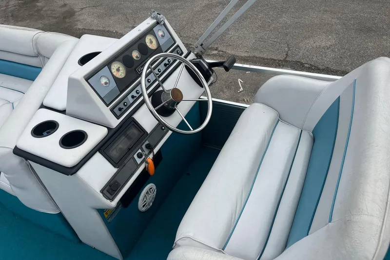 Slide: The Image of 1992 Harris FloteBote 240 Classic boat interior with steering wheel and dashboard controls. - 9