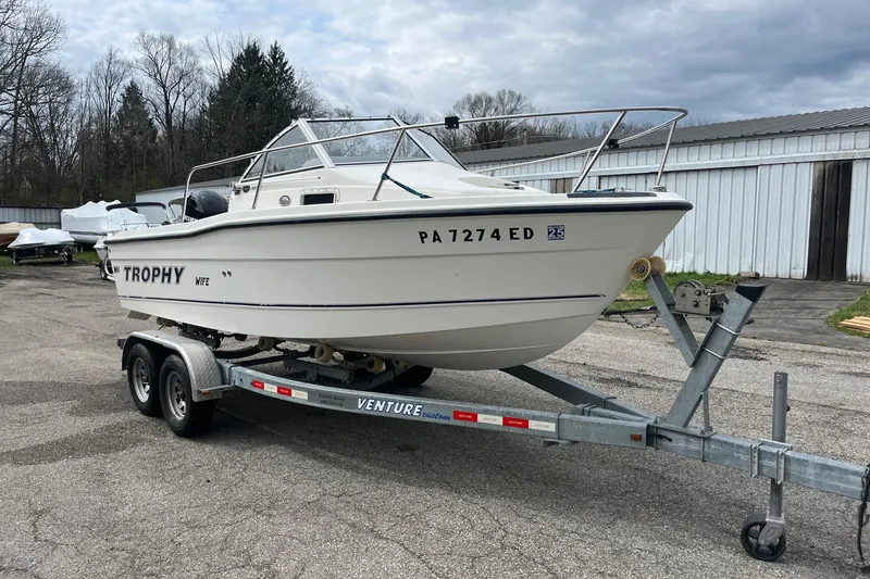 The Image of 2010 Trophy 1802 Walkaround boat on trailer, parked outdoors. - 1