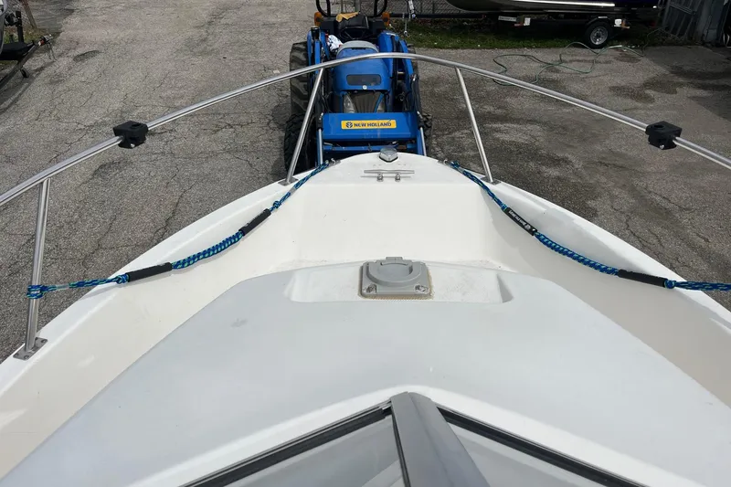 Slide: The Image of Bow view of 2010 Trophy 1802 Walkaround boat with blue ropes and tractor in background. - 10