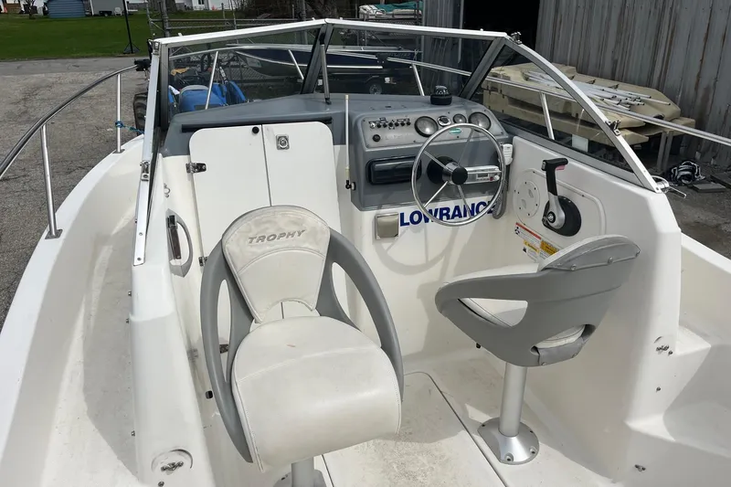 Slide: The Image of 2010 Trophy 1802 Walkaround boat interior with steering wheel and seating. - 8