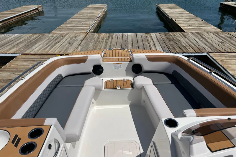 Slide: The Image of 2026 Starcraft SVX 211 OB boat interior with spacious seating at a dock. - 11