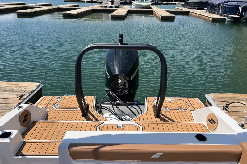 Slide: The Image of 2026 Starcraft SVX 211 OB boat docked, showcasing rear deck and outboard motor. - 13