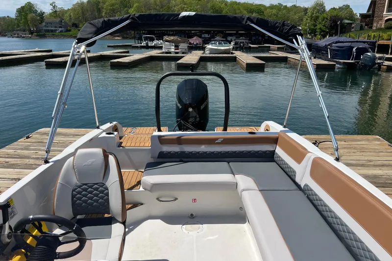 Slide: The Image of 2026 Starcraft SVX 211 OB boat docked, featuring spacious seating and sleek design. - 5