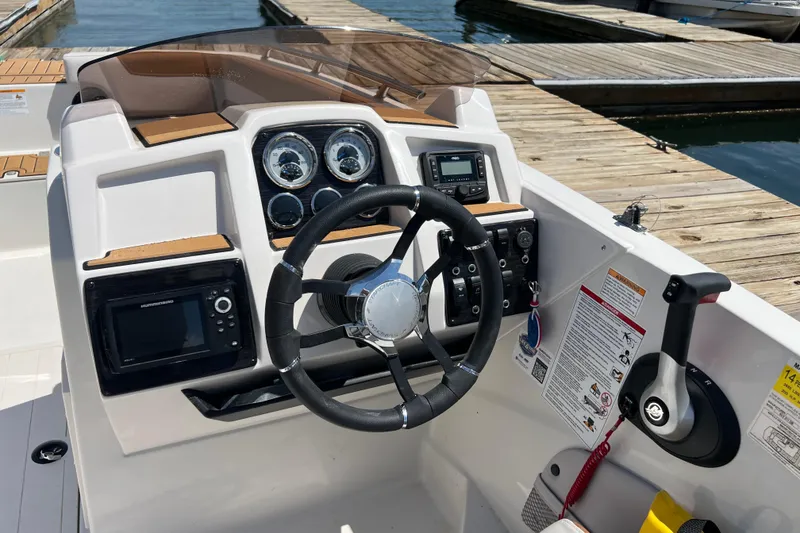 Slide: The Image of 2026 Starcraft SVX 211 OB boat dashboard with steering wheel and control panel. - 6