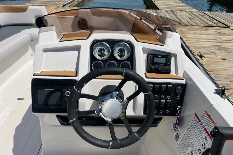 Slide: The Image of 2026 Starcraft SVX 211 OB boat dashboard with steering wheel, gauges, and control panel. - 7