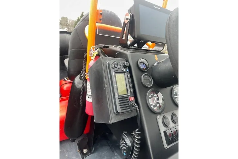 Slide: The Image of Control panel of a 1997 Zodiac boat with navigation equipment and gauges. - 11