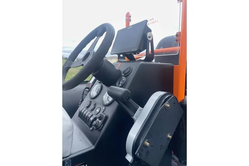 Slide: The Image of Control panel of a 1997 Zodiac boat featuring steering wheel and navigation equipment. - 13