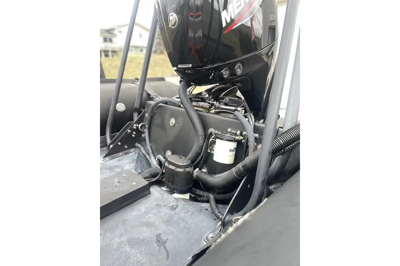 Slide: The Image of Close-up of a 1997 Zodiac boat engine with visible components and wiring. - 17