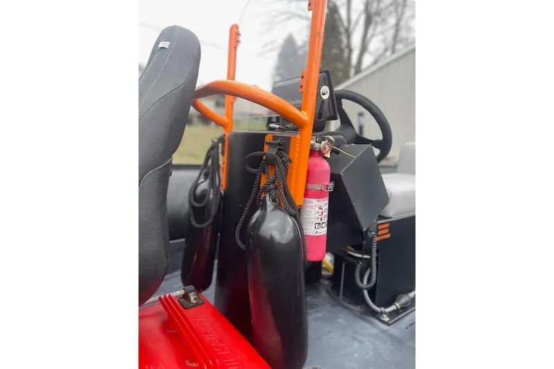 Slide: The Image of Interior of a 1997 Zodiac boat with safety equipment and steering wheel. - 19