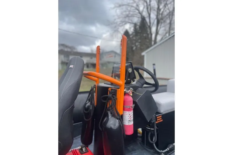 Slide: The Image of Interior of a 1997 Zodiac boat with safety equipment and steering wheel. - 20