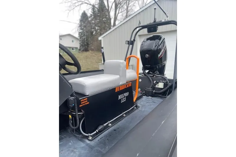 Slide: The Image of Zodiac Hurricane Milpro 533 boat with Mercury engine, 1997 model, parked outdoors. - 21