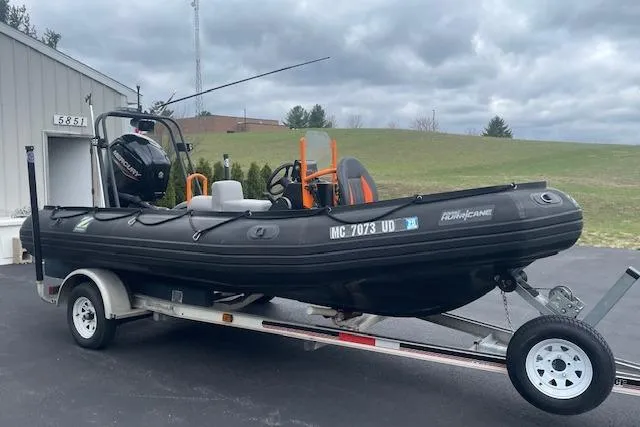 Slide: The Image of 1997 Zodiac inflatable boat on trailer, parked outdoors under cloudy sky. - 4