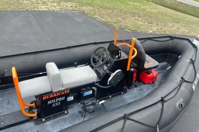 Slide: The Image of 1997 Zodiac inflatable boat with steering console and seating, labeled "Hurricane Milpro 533." - 5