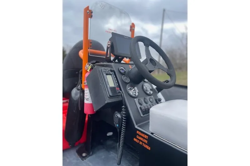 Slide: The Image of Control panel of a 1997 Zodiac boat with steering wheel and gauges. - 8