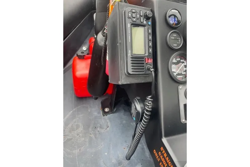 Slide: The Image of Control panel of a 1997 Zodiac boat with radio and gauges. - 9