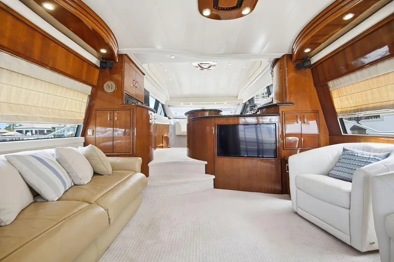 Slide: The Image of Luxurious interior of a 2006 Marquis 59 yacht with elegant wood finishes and plush seating. - 10