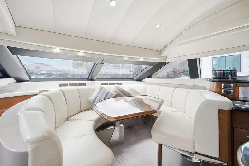 Slide: The Image of Luxurious interior of a 2006 Marquis 59 yacht with plush seating and elegant table. - 14