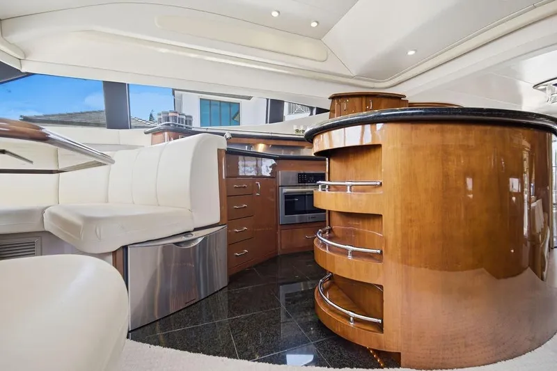 Slide: The Image of Luxurious interior of a 2006 Marquis 59 yacht featuring elegant wood cabinetry and modern appliances. - 16