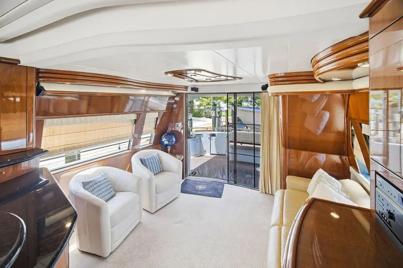 Slide: The Image of Luxurious interior of a 2006 Marquis 59 yacht with elegant seating and wood finishes. - 18