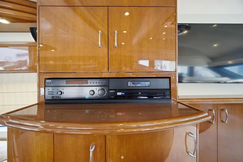 Slide: The Image of Luxurious wood interior of a 2006 Marquis 59 yacht with built-in audio system. - 19