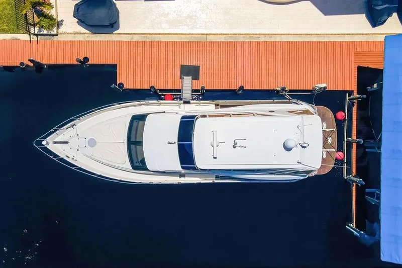 Slide: The Image of Aerial view of a 2006 Marquis 59 yacht docked at a marina. - 2