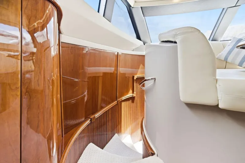 Slide: The Image of Luxurious interior of a 2006 Marquis 59 yacht with polished wood and plush seating. - 21