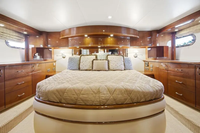 Slide: The Image of Luxurious 2006 Marquis 59 yacht bedroom with elegant wood finish and plush bedding. - 22