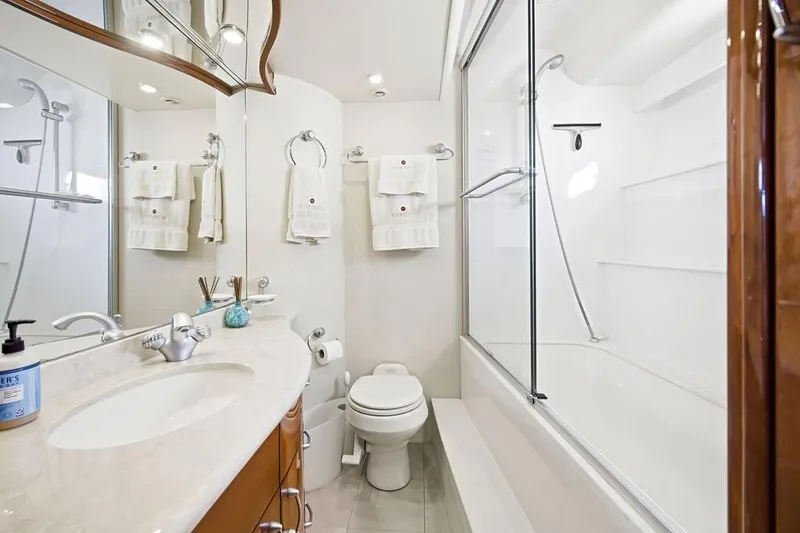 Slide: The Image of Luxurious 2006 Marquis 59 yacht bathroom with elegant fixtures and glass-enclosed shower. - 24