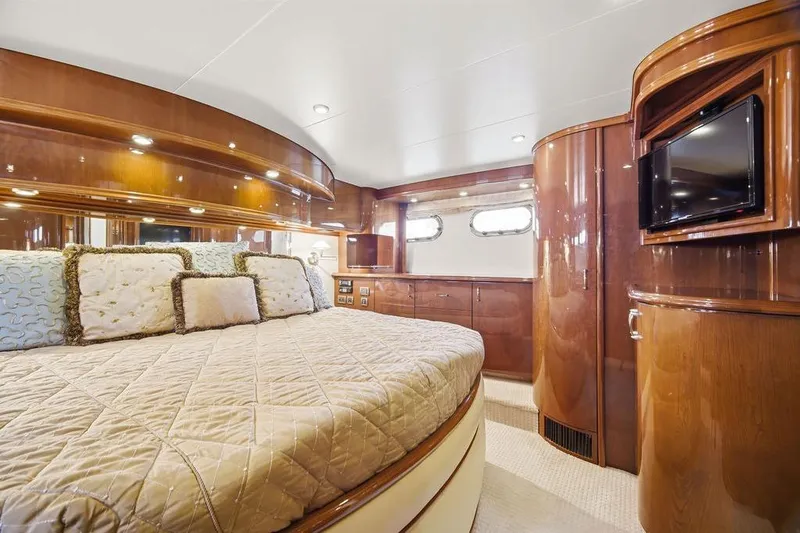 Slide: The Image of Luxurious 2006 Marquis 59 yacht bedroom with elegant wood finishes and plush bedding. - 25