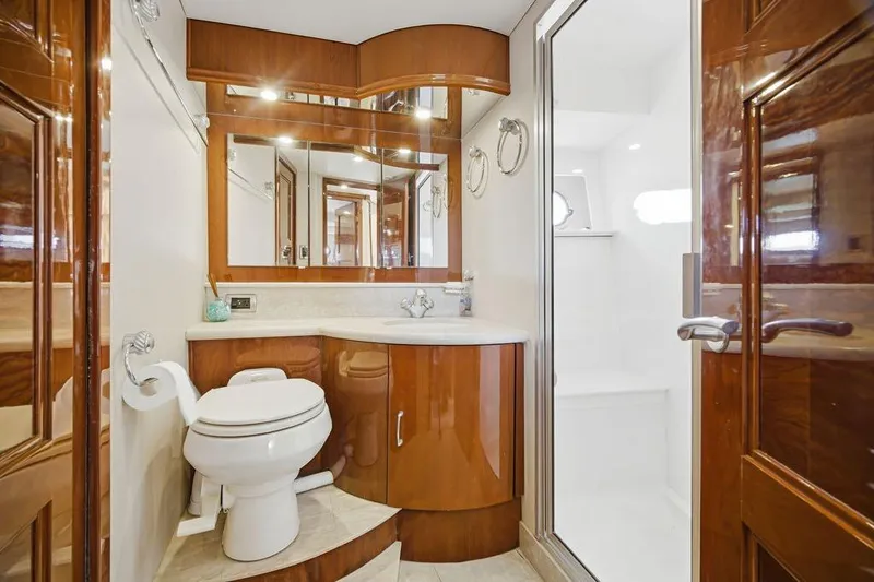 Slide: The Image of Luxurious 2006 Marquis 59 yacht bathroom with elegant wood finishes and modern fixtures. - 30