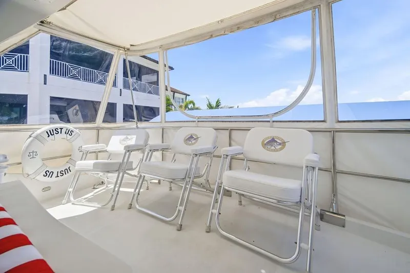 Slide: The Image of Spacious deck of 2006 Marquis 59 yacht with white chairs and life preserver. - 37
