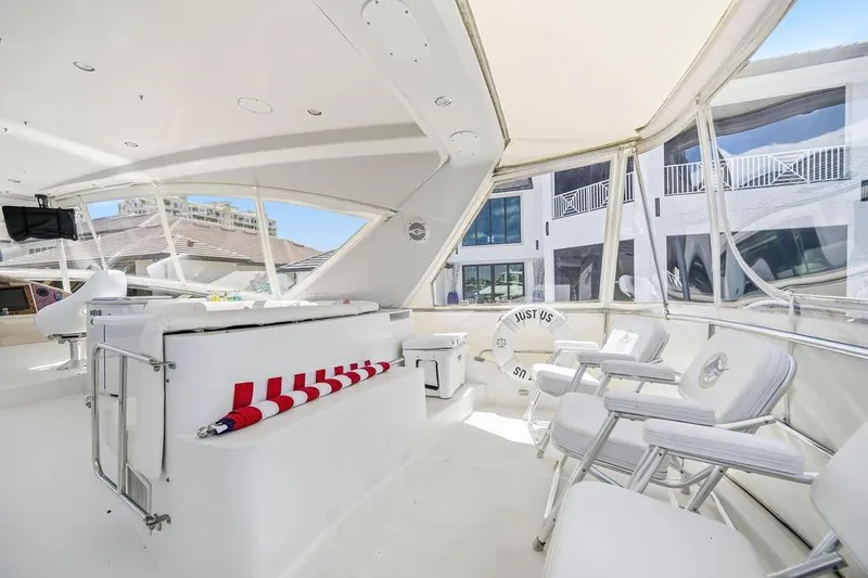 Slide: The Image of Luxurious 2006 Marquis 59 yacht interior with white seating and panoramic windows. - 38