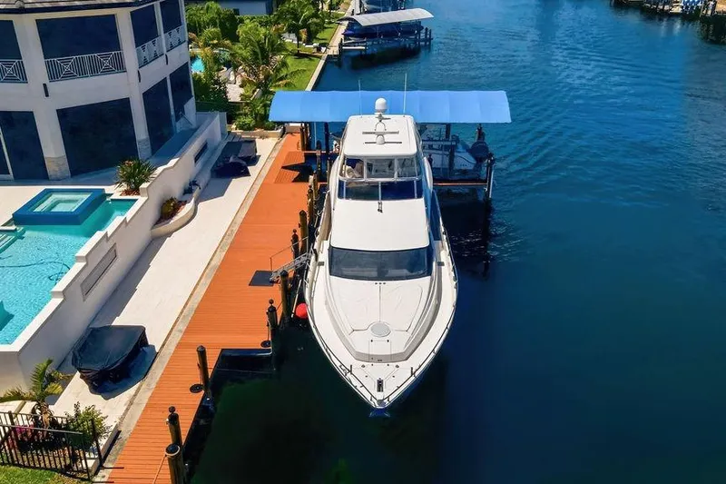 Slide: The Image of Luxury 2006 Marquis 59 yacht docked beside waterfront property with pool. - 4