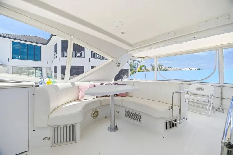 Slide: The Image of Luxurious 2006 Marquis 59 yacht interior with white seating and ocean view. - 40