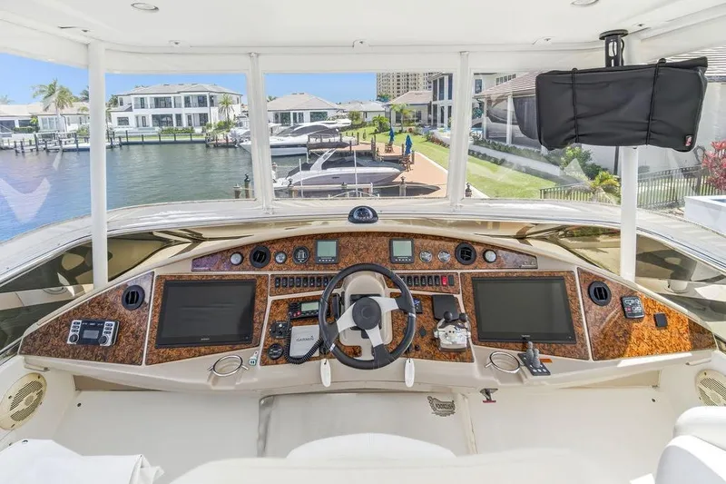 Slide: The Image of Luxurious 2006 Marquis 59 yacht helm with advanced navigation systems and waterfront view. - 43