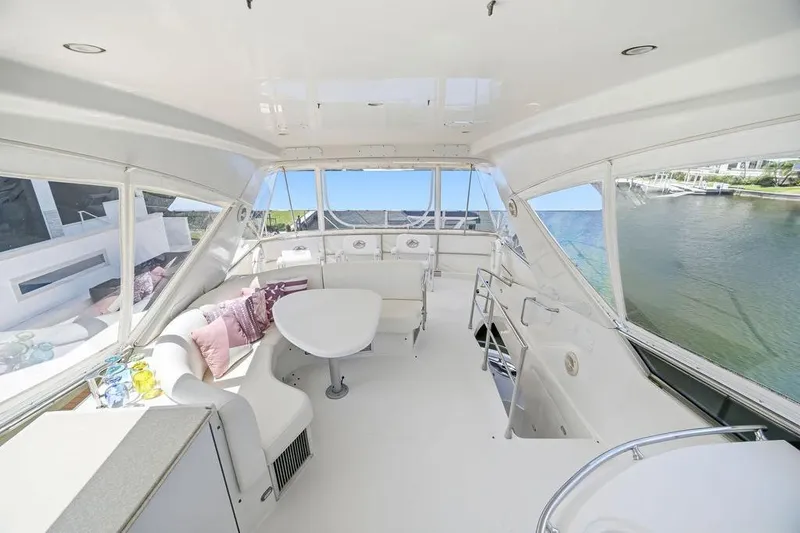 Slide: The Image of Luxurious 2006 Marquis 59 yacht interior with panoramic windows and elegant seating. - 45