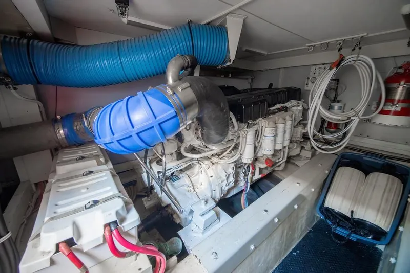 Slide: The Image of Engine room of a 2006 Marquis 59 yacht, featuring a powerful marine engine. - 49