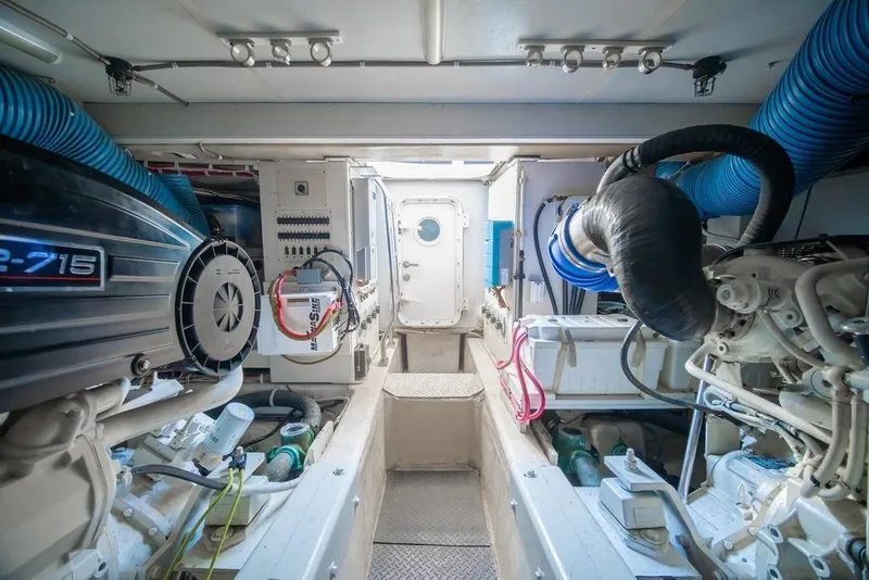 Slide: The Image of Engine room of a 2006 Marquis 59 yacht, featuring mechanical equipment and ventilation systems. - 50