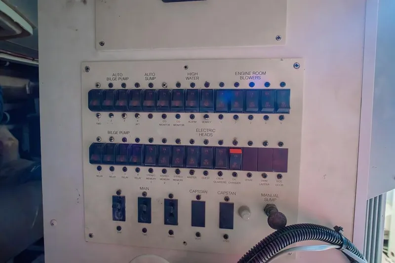 Slide: The Image of Control panel of a 2006 Marquis 59 yacht with various switches and indicators. - 51