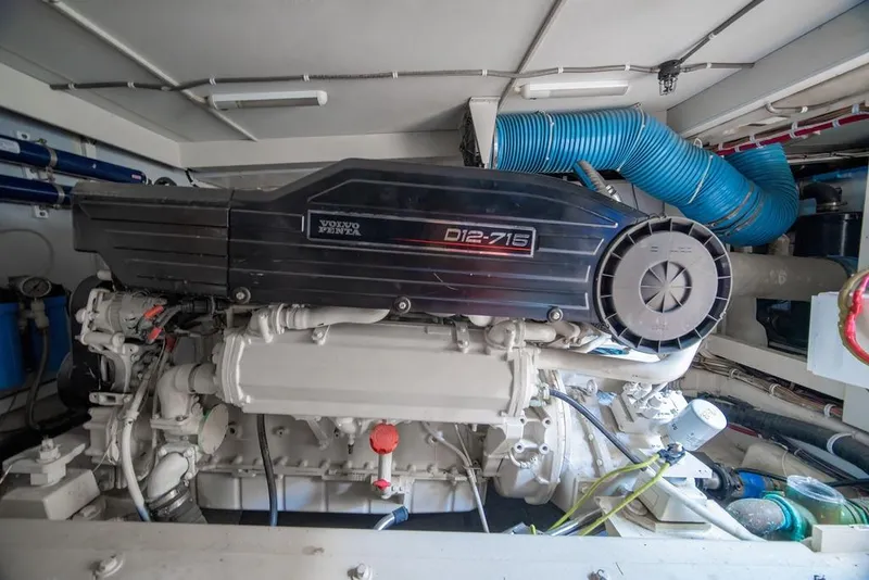 Slide: The Image of Engine room of a 2006 Marquis 59 yacht featuring a Volvo Penta D12-715 engine. - 55