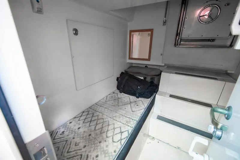 Slide: The Image of 2006 Marquis 59 yacht interior with storage area and steps. - 57