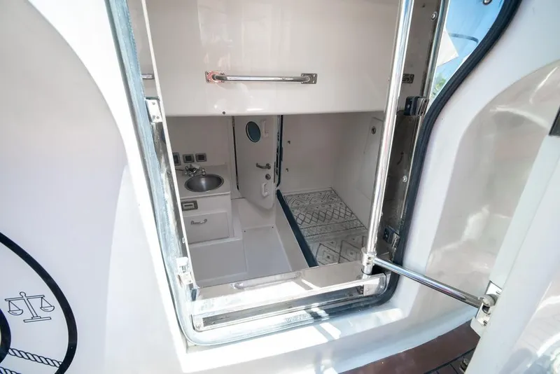 Slide: The Image of Interior view of a 2006 Marquis 59 yacht bathroom with sink and door. - 59