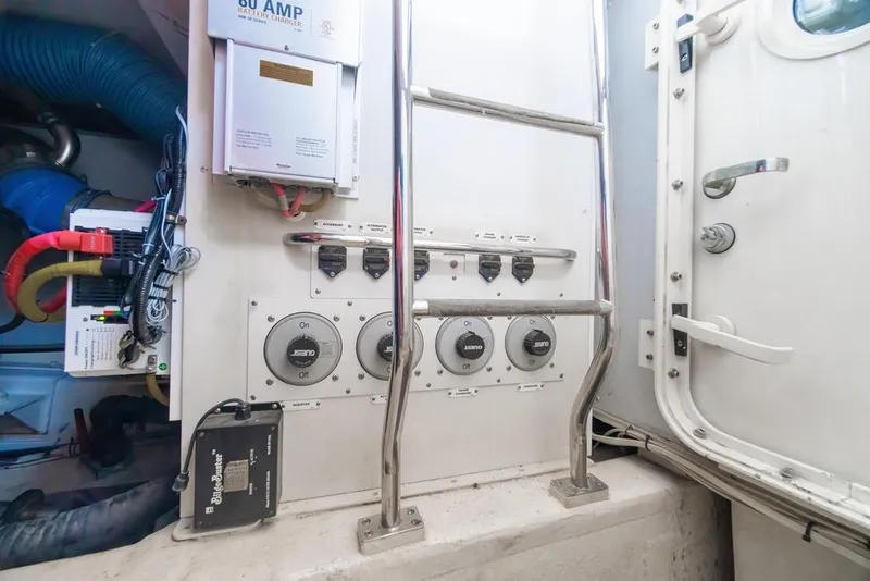 Slide: The Image of Engine room of a 2006 Marquis 59 yacht with control panel and ladder. - 61