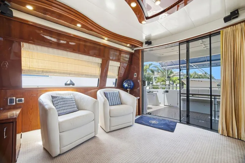 Slide: The Image of Luxurious interior of a 2006 Marquis 59 yacht with plush seating and elegant decor. - 9