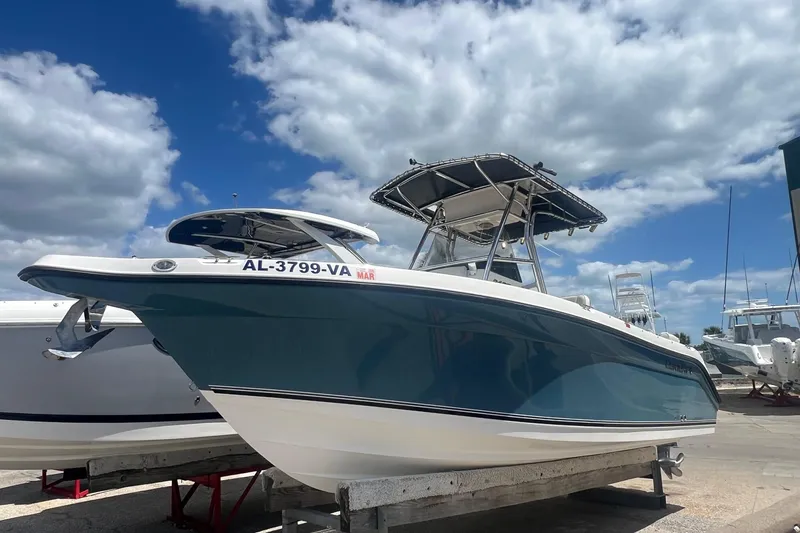 The Image of 2007 Century 2400 Center Console boat on display under a partly cloudy sky. - 1
