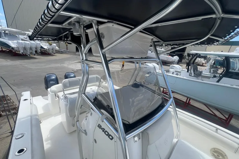 Slide: The Image of 2007 Century 2400 Center Console boat with dual engines, docked in a marina. - 11