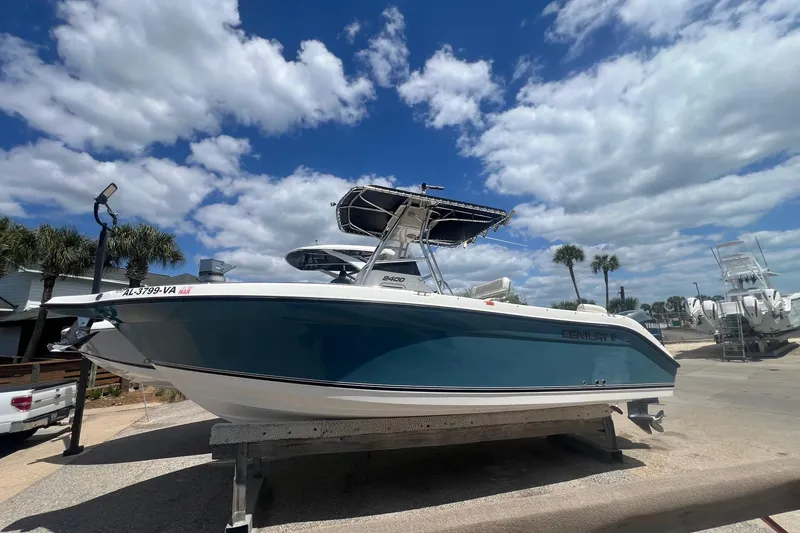 Slide: The Image of 2007 Century 2400 Center Console boat on a trailer under a blue sky with clouds. - 6