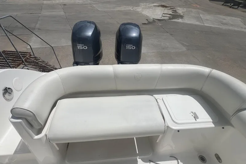 Slide: The Image of 2007 Century 2400 Center Console boat with Yamaha 150 engines and cushioned seating. - 7