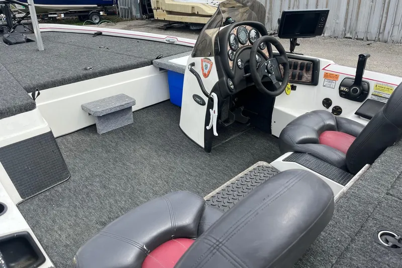 Slide: The Image of 1999 Nitro 896 Savage boat interior with steering console and seating. - 10