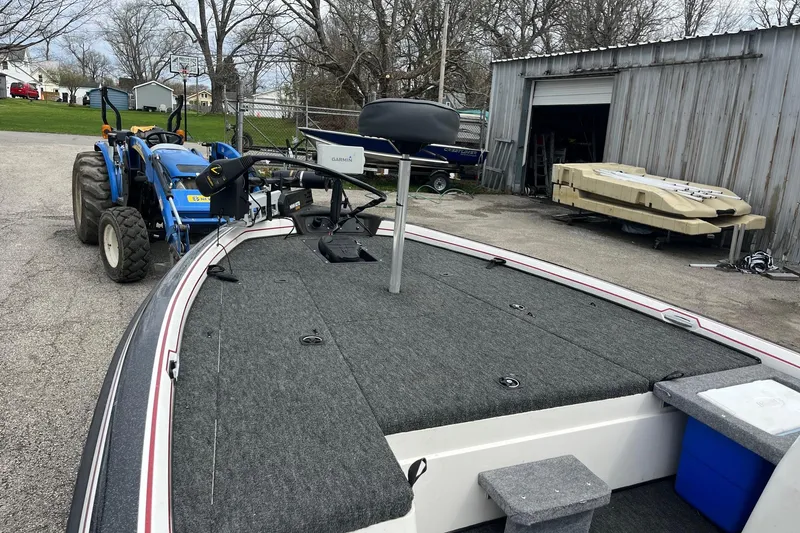 Slide: The Image of ```json { "alt_text": "1999 Nitro 896 Savage boat with tractor in driveway near garage." } ``` - 9